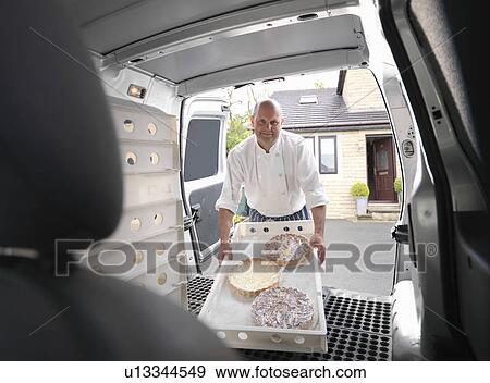 Pastry chef loading cakes into van View Large Photo Image Stock Photo - Pastry chef loading cakes into van. Fotosearch