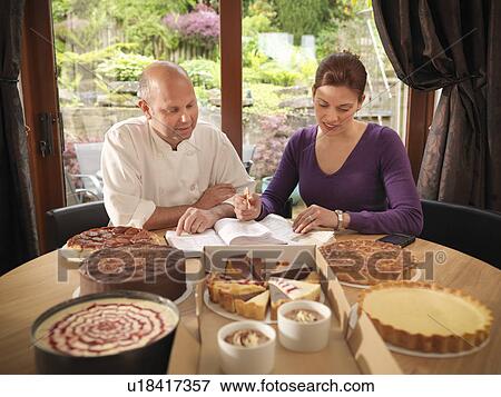 Stock Photo - Pastry chef working with customer . Fotosearch