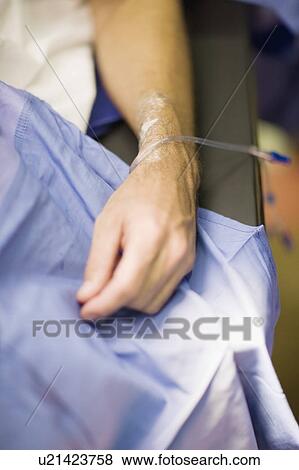 Stock Photo - Patient with intravenous drip in arm. Fotosearch