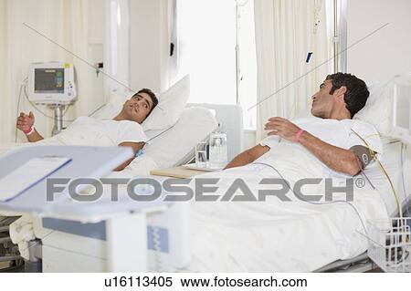 Stock Photography - Patients talking in hospital beds. Fotosearch
