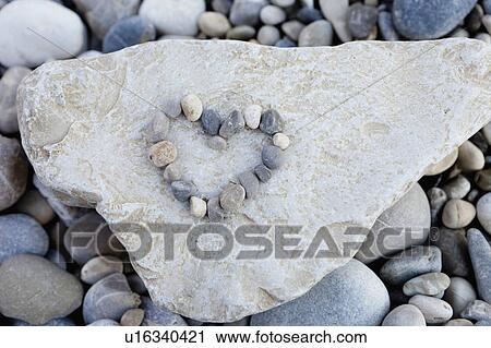 Pebbles forming heart on stone View Large Photo Image Stock Image - Pebbles forming heart on stone. Fotosearch