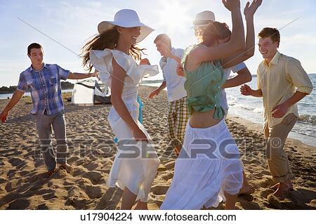 People dancing together on beach View Large Photo Image Picture - People dancing together on beach. Fotosearch