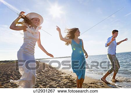 People dancing together on beach View Large Photo Image Stock Photo - People dancing together on beach. Fotosearch