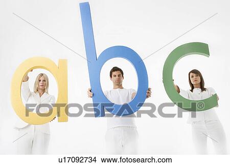 Picture - People holding letters a, b, c. Fotosearch