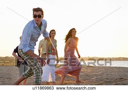 People playing on beach together View Large Photo Image Stock Image - People playing on beach together. Fotosearch