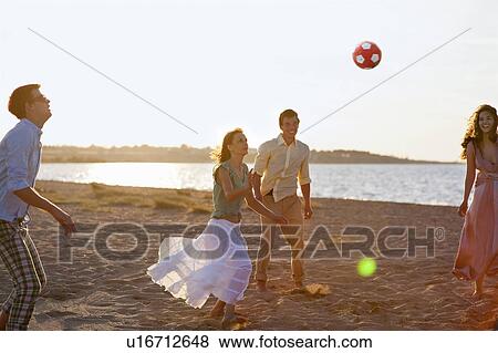 People playing with soccer ball on beach View Large Photo Image Stock Photo - People playing with soccer ball on beach. Fotosearch