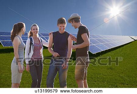 Stock Photo - People talking by solar panels. Fotosearch