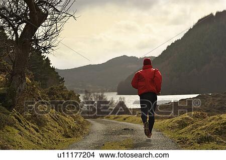 Person running on rural road View Large Photo Image Picture - Person running on rural road. Fotosearch
