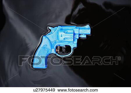 Plastic gun floating in black liquid View Large Photo Image Stock Photo - Plastic gun floating in black liquid. Fotosearch