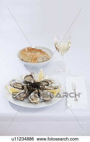 Plate of oysters and bread View Large Photo Image Stock Photograph - Plate of oysters and bread. Fotosearch