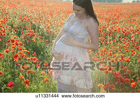 Pregnant woman holding her belly View Large Photo Image Picture - Pregnant woman holding her belly. Fotosearch