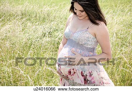 Pregnant woman holding her belly View Large Photo Image Stock Photograph - Pregnant woman holding her belly. Fotosearch