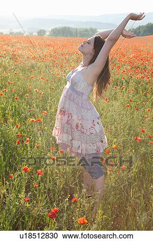 Pregnant woman in field of flowers View Large Photo Image Stock Image - Pregnant woman in field of flowers. Fotosearch