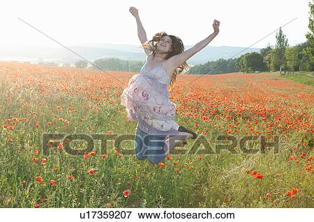 Pregnant woman in field of flowers View Large Photo Image Stock Photo - Pregnant woman in field of flowers. Fotosearch