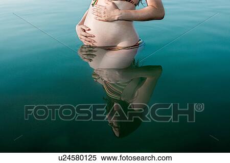 Pregnant woman standing in lake View Large Photo Image Stock Photography - Pregnant woman standing in lake. Fotosearch