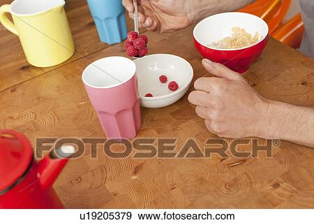 Raspberries and cereal at breakfast View Large Photo Image Stock Photo - Raspberries and cereal at breakfast. Fotosearch