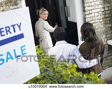 Realtor showing couple property for sale View Large Photo Image Picture - Realtor showing couple property for sale. Fotosearch