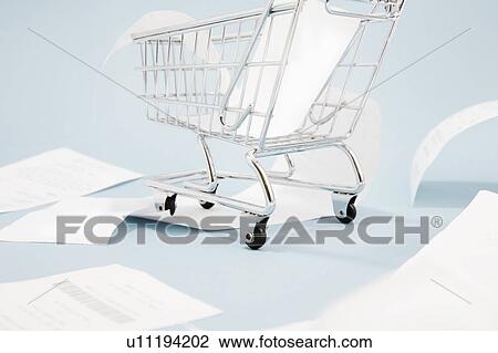Stock Image - Receipts spilling out of shopping cart. Fotosearch