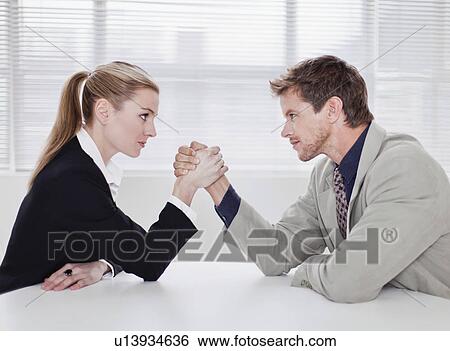 Rival business people arm wrestling View Large Photo Image Stock Photograph - Rival business people arm wrestling. Fotosearch
