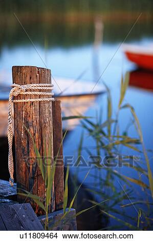 Rope tied on wooden post at dock View Large Photo Image Picture - Rope tied on wooden post at dock. Fotosearch