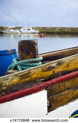 Stock Photo - Rope wrapped around wooden dock post. Fotosearch