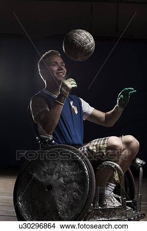 Rugby player in wheelchair with ball View Large Photo Image Picture - Rugby player in wheelchair with ball. Fotosearch