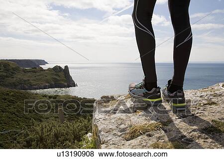 Runner admiring coastal landscape View Large Photo Image Stock Photo - Runner admiring coastal landscape. Fotosearch