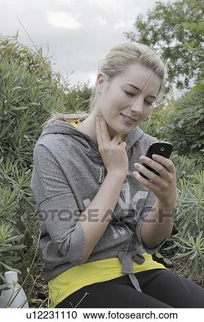Runner checking her pulse in park View Large Photo Image Stock Image - Runner checking her pulse in park. Fotosearch