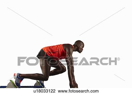 Runner crouched at starting line View Large Photo Image Stock Image - Runner crouched at starting line. Fotosearch