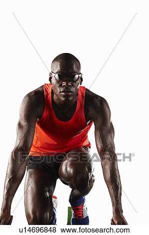 Runner crouched at starting line View Large Photo Image Stock Photo - Runner crouched at starting line. Fotosearch