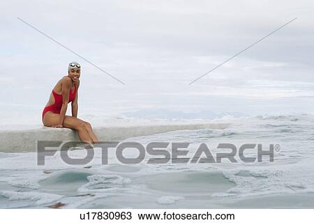 Runner sitting on dock by water View Large Photo Image Stock Image - Runner sitting on dock by water. Fotosearch