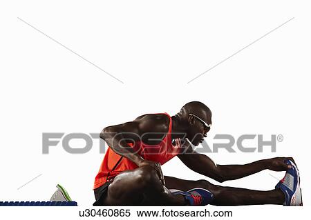 Runner stretching at starting line View Large Photo Image Stock Photography - Runner stretching at starting line. Fotosearch