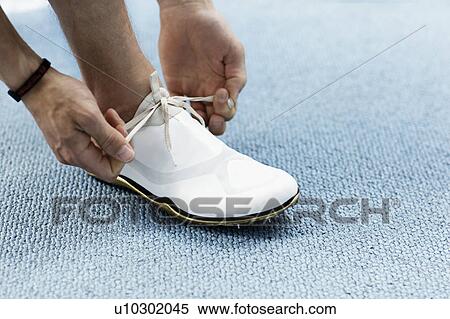 Runner tying shoelaces View Large Photo Image Stock Photography - Runner tying shoelaces. Fotosearch