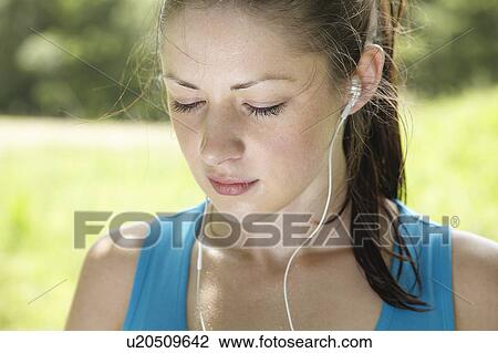 Stock Image - Runner wearing headphones. Fotosearch