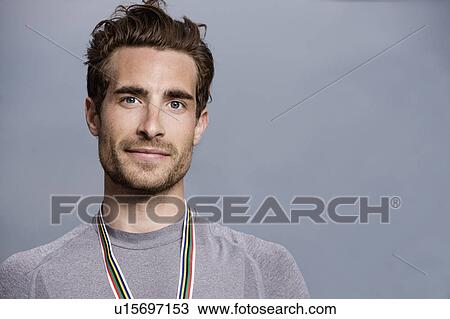 Stock Image - Runner wearing medal. Fotosearch