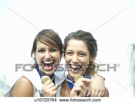 Picture - Runners celebrating with medals. Fotosearch