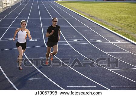 Runners racing on track View Large Photo Image Stock Photo - Runners racing on track. Fotosearch