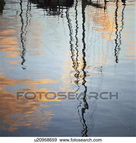Stock Photo - Sailboats reflected in water. Fotosearch