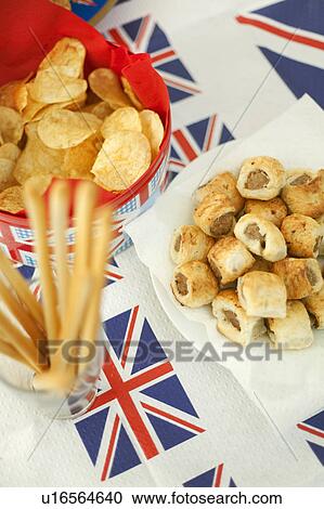Stock Image - Sausage rolls, crisps and breadsticks. Fotosearch