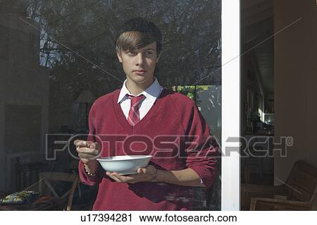 Schoolboy eating bowl of cereal View Large Photo Image Stock Image - Schoolboy eating bowl of cereal. Fotosearch