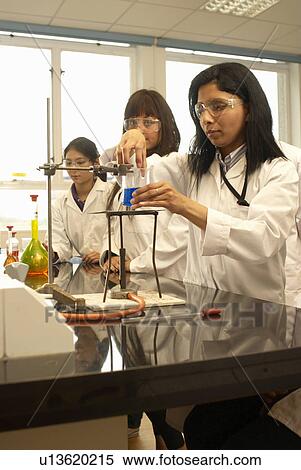 Stock Photography - Scientist heating liquid in beaker. Fotosearch
