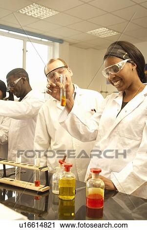 Stock Image - Scientists at work in lab. Fotosearch