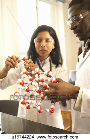 Scientists examining molecular model View Large Photo Image Picture - Scientists examining molecular model. Fotosearch