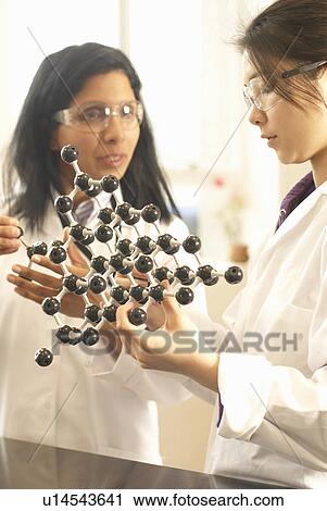 Scientists examining molecular model View Large Photo Image Stock Image - Scientists examining molecular model. Fotosearch