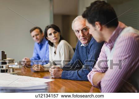 Stock Photo - Serious business people in meeting. Fotosearch