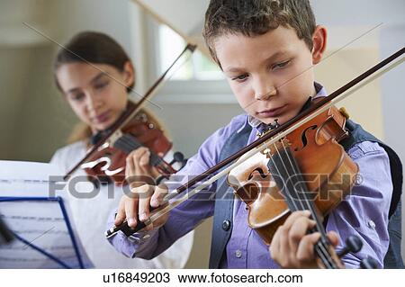 Serious children playing violin View Large Photo Image Stock Image - Serious children playing violin. Fotosearch