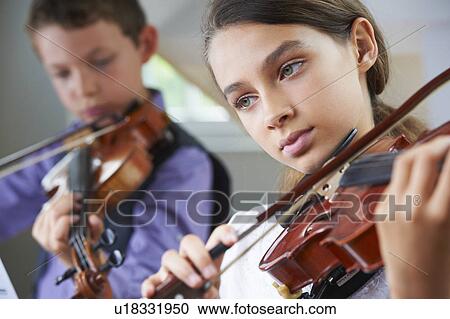 Serious children playing violin View Large Photo Image Stock Image - Serious children playing violin. Fotosearch