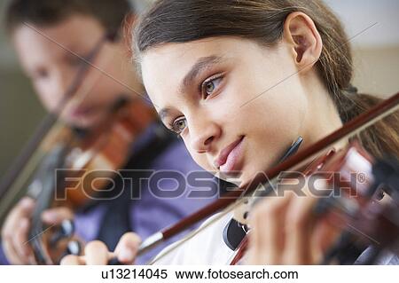 Stock Photography - Serious children playing violin. Fotosearch