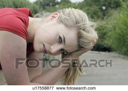 Serious woman resting in park View Large Photo Image Stock Photo - Serious woman resting in park . Fotosearch