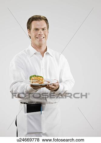 Server carrying plate of food View Large Photo Image Stock Photo - Server carrying plate of food. Fotosearch